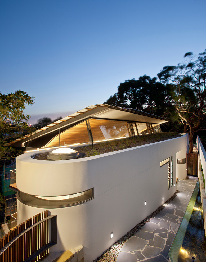 Photo of a mid-sized contemporary two-storey white exterior in Sydney with a flat roof.