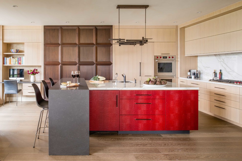 Design ideas for a mid-sized contemporary kitchen in DC Metro with an undermount sink, flat-panel cabinets, red cabinets, marble benchtops, white splashback, marble splashback, stainless steel appliances, light hardwood floors, multiple islands and beige floor.