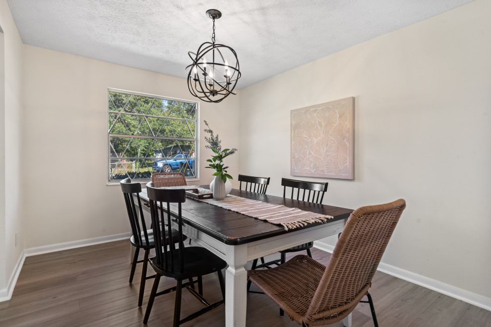 This is an example of a mid-sized country dining room in Jacksonville with white walls and vinyl floors.