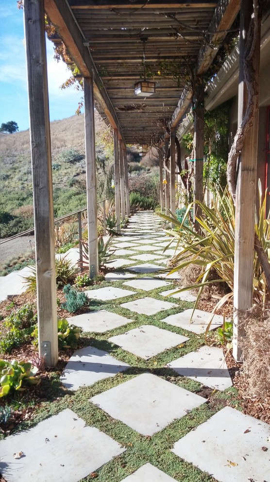 Photo of a country garden in Santa Barbara with natural stone pavers.