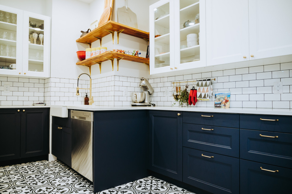 Small transitional galley ceramic tile and multicolored floor enclosed kitchen photo with a farmhouse sink, recessed-panel cabinets, blue cabinets, quartz countertops, white backsplash, subway tile backsplash, stainless steel appliances, no island and white countertops