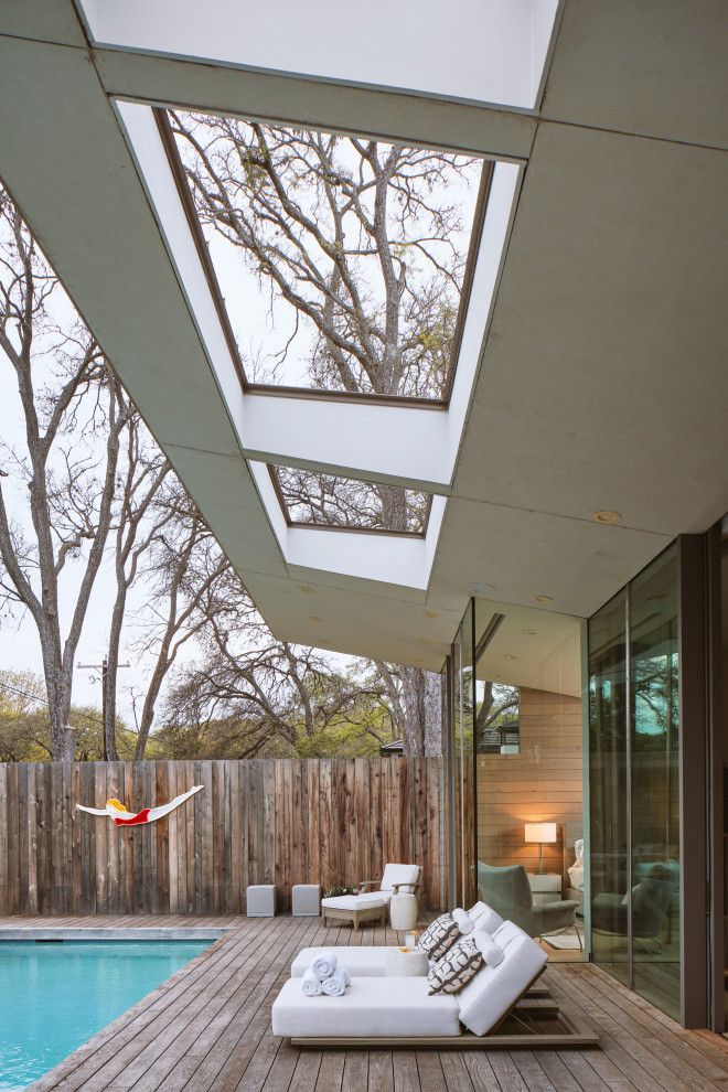Photo of a mid-sized contemporary backyard patio in Austin with a roof extension.