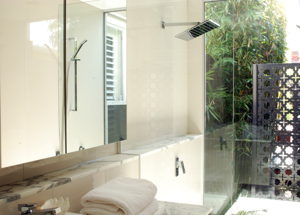 Inspiration for a contemporary master bathroom in Melbourne with marble benchtops, an open shower and beige tile.