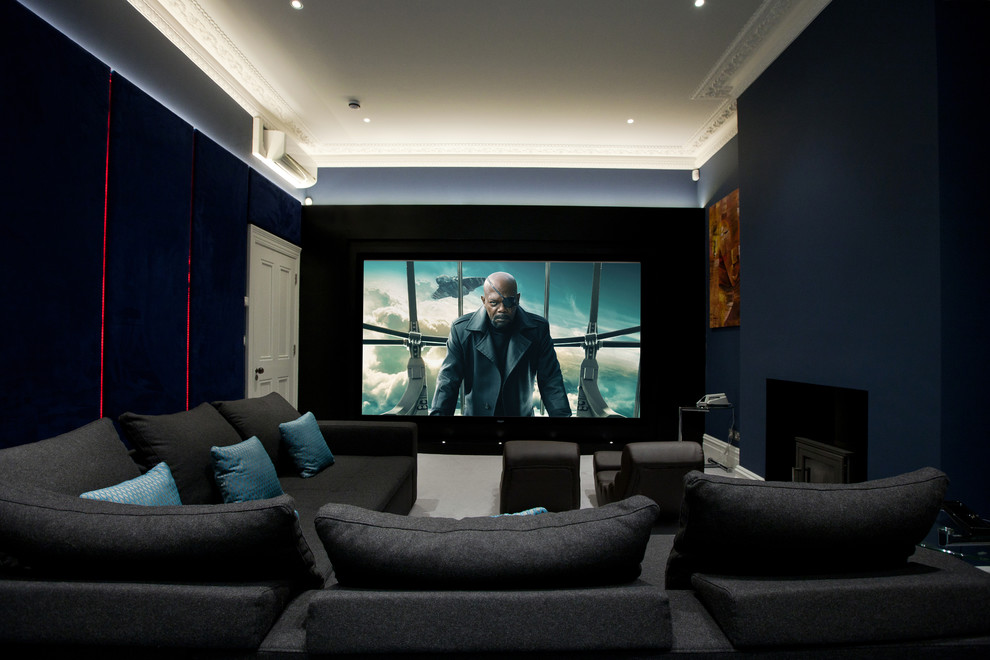 Photo of a mid-sized contemporary enclosed home theatre in London with black walls, carpet and a projector screen.