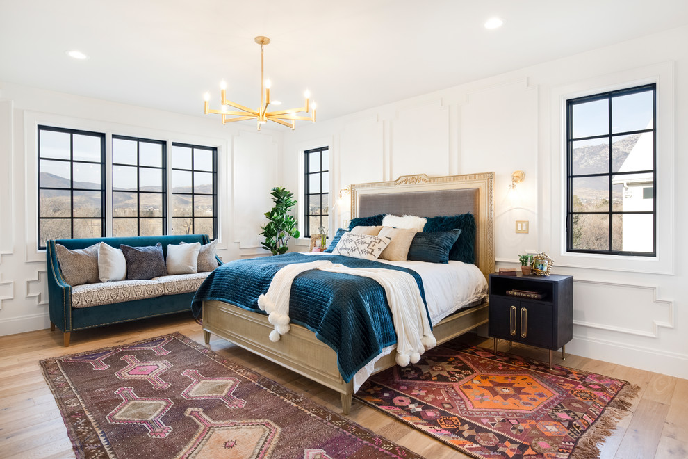 Large transitional master bedroom in Salt Lake City with white walls, medium hardwood floors and brown floor.
