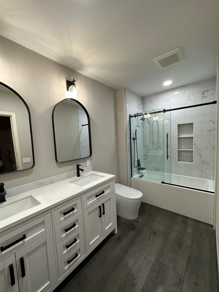 This is an example of a mid-sized contemporary kids bathroom in Seattle with white cabinets, an alcove tub, an alcove shower, a bidet, white tile, porcelain tile, grey walls, ceramic floors, an undermount sink, engineered quartz benchtops, grey floor, a sliding shower screen, white benchtops, a double vanity and a freestanding vanity.