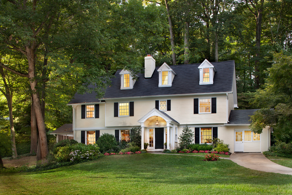Design ideas for a traditional three-storey yellow exterior in DC Metro with wood siding.