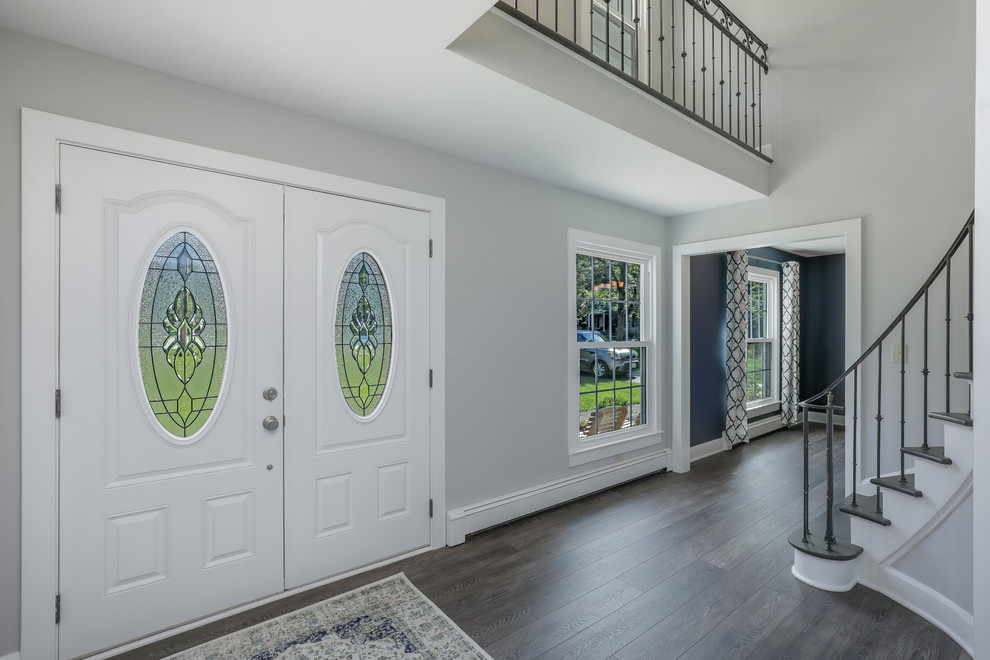 Photo of a mid-sized transitional foyer in Cleveland with grey walls, medium hardwood floors, a double front door and a white front door.