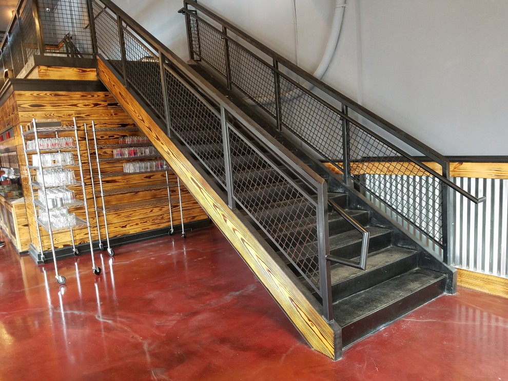 Inspiration for a mid-sized industrial metal straight staircase in Wilmington with metal risers and metal railing.