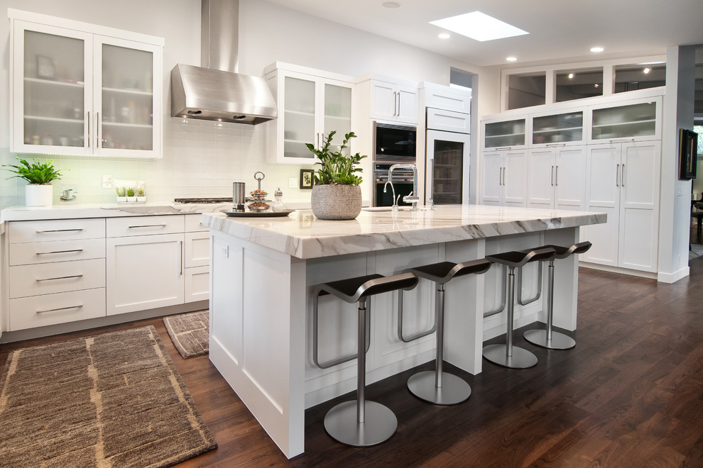 Photo of a contemporary u-shaped kitchen in Salt Lake City with shaker cabinets, white cabinets and white splashback.