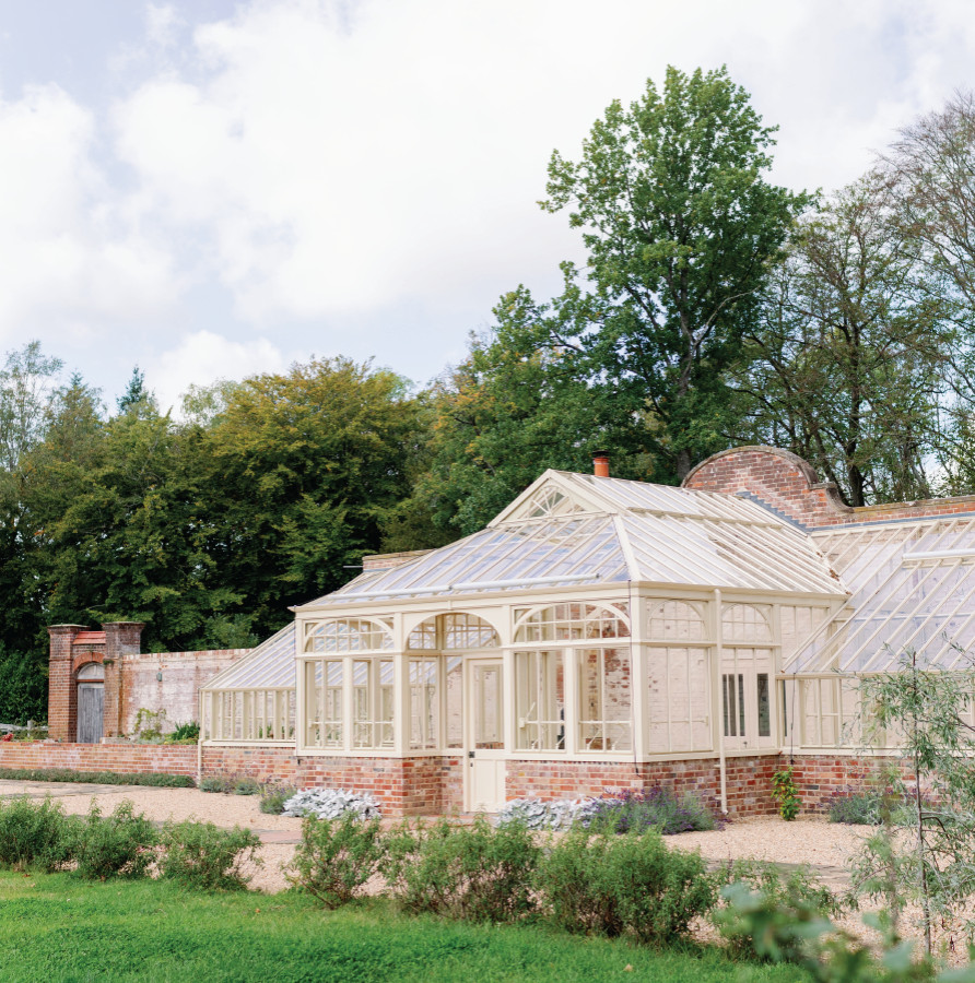 Photo of an expansive traditional attached greenhouse in Surrey.