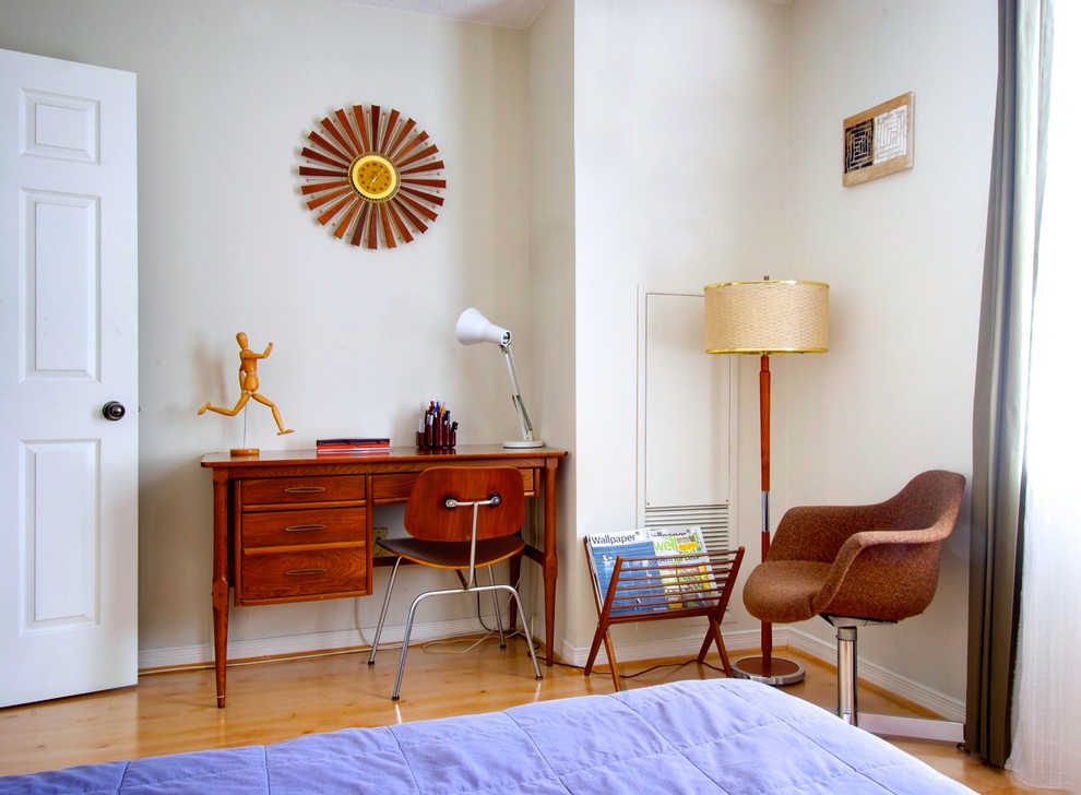 This is an example of a midcentury bedroom in Toronto with white walls and medium hardwood floors.