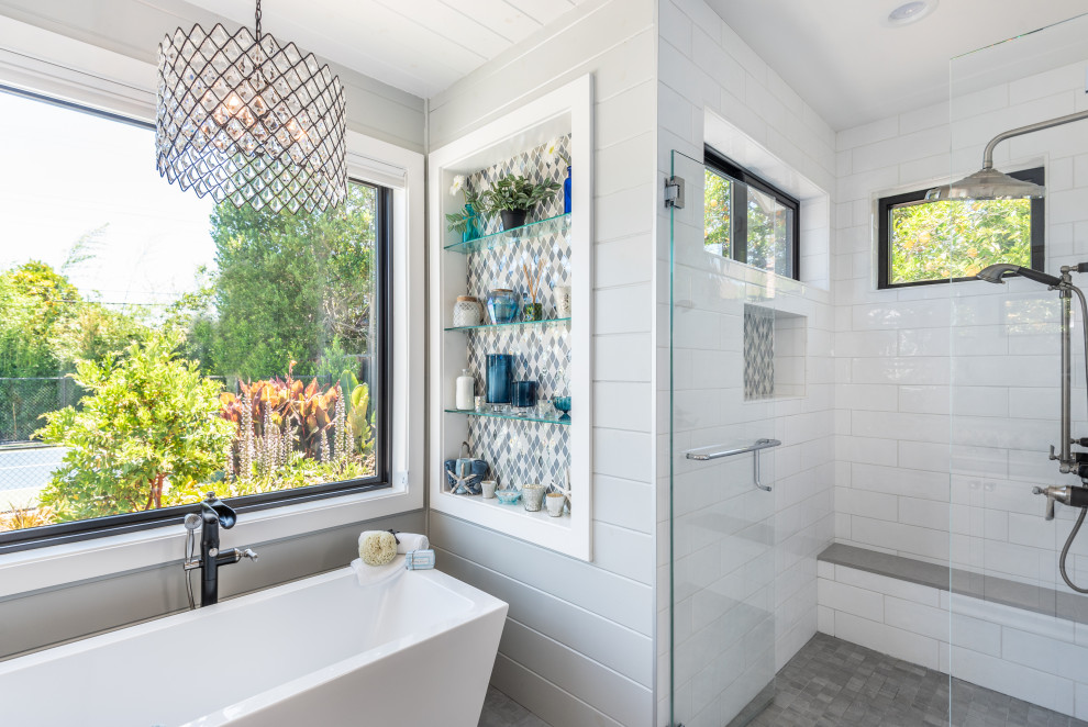 Photo of a large country master bathroom in San Francisco with shaker cabinets, white cabinets, a freestanding tub, a curbless shower, a one-piece toilet, multi-coloured tile, ceramic tile, white walls, marble floors, an undermount sink, engineered quartz benchtops, grey floor, a hinged shower door, grey benchtops, a shower seat, a double vanity, a built-in vanity, timber and planked wall panelling.