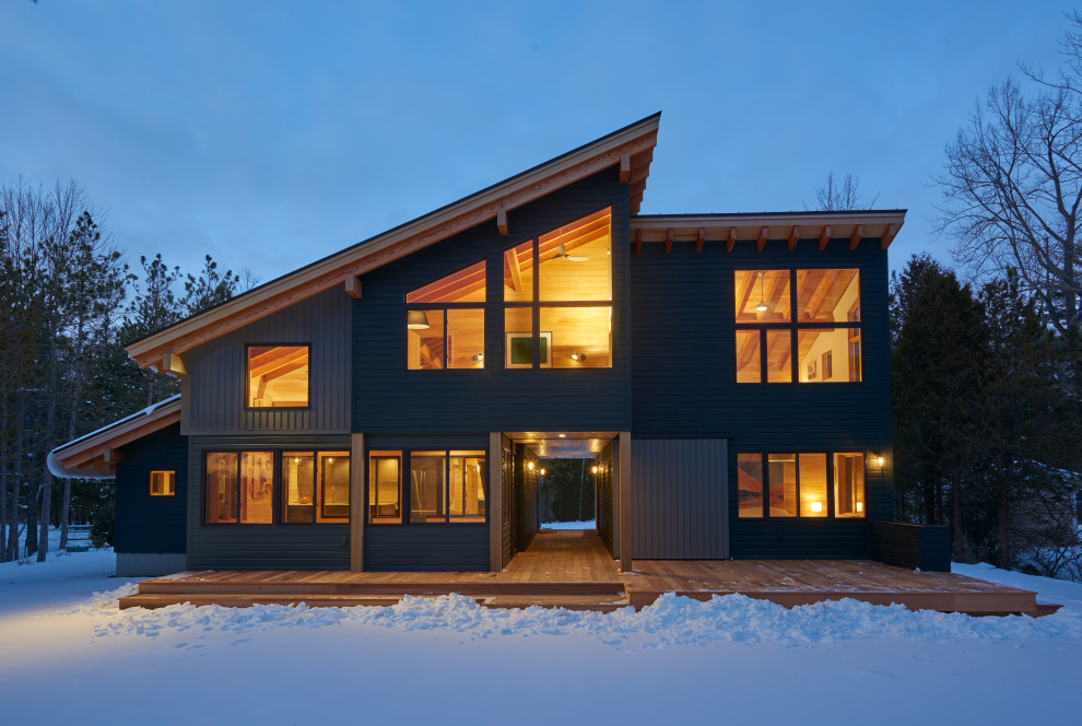Mittelgroßes, Zweistöckiges Uriges Einfamilienhaus mit Mix-Fassade, grüner Fassadenfarbe, Pultdach, Blechdach und braunem Dach