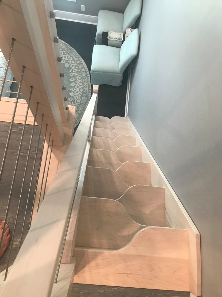 Photo of a small modern wood straight staircase in Tampa with open risers and mixed railing.