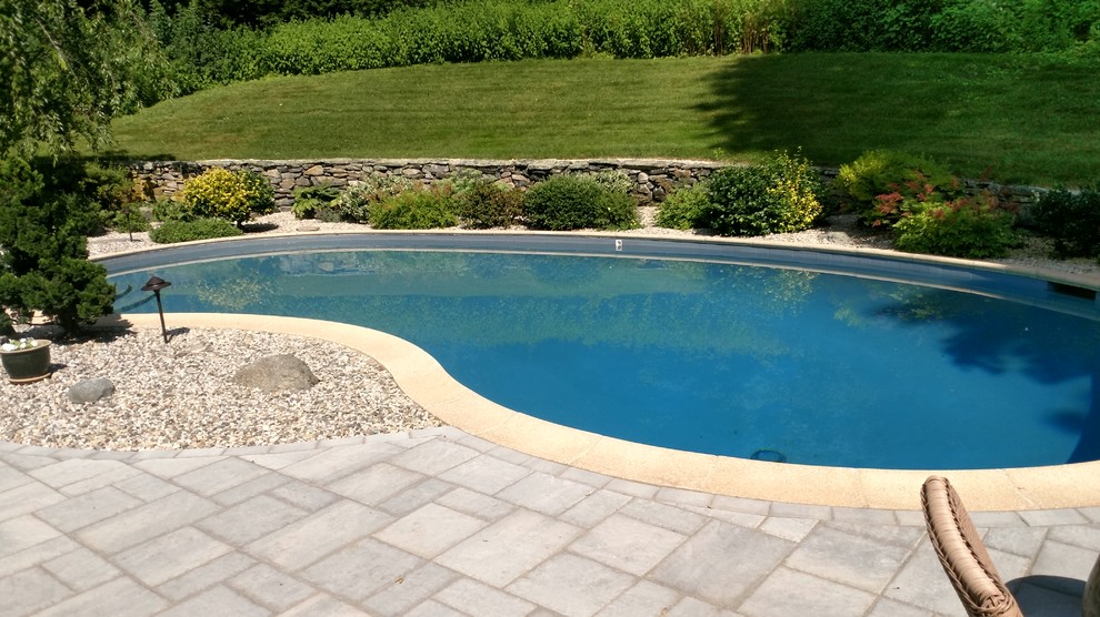 Example of a mid-sized backyard concrete paver full sun pool design in Boston