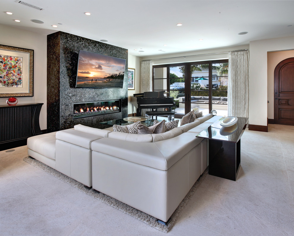 This is an example of a contemporary enclosed living room in Phoenix with a music area, white walls, concrete floors, a ribbon fireplace, a stone fireplace surround, a wall-mounted tv and grey floor.