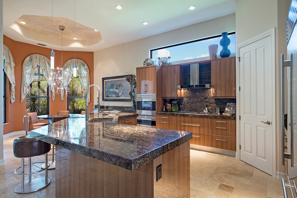 Example of a large transitional galley travertine floor and beige floor eat-in kitchen design in Miami with an undermount sink, flat-panel cabinets, light wood cabinets, granite countertops, multicolored backsplash, stone slab backsplash, stainless steel appliances and an island