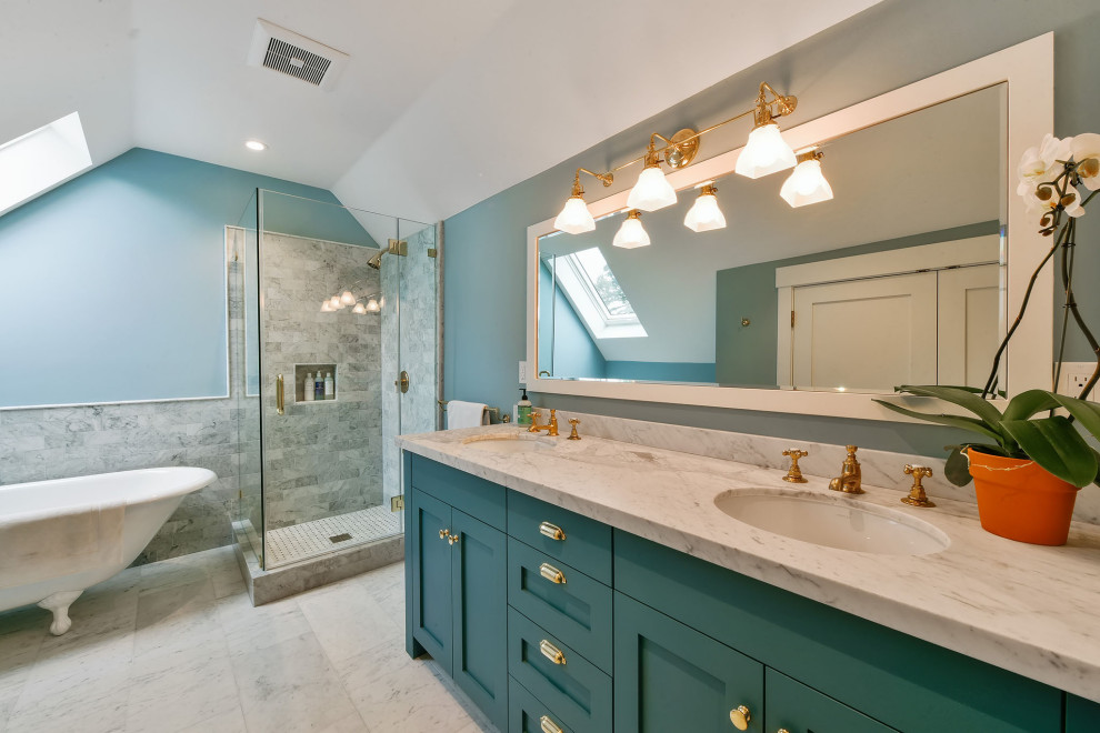 Photo of a traditional bathroom in San Francisco with shaker cabinets, turquoise cabinets, a claw-foot tub, a corner shower, gray tile, blue walls, an undermount sink, white floor, a hinged shower door and white benchtops.