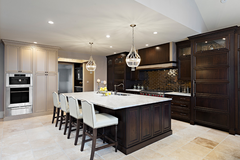 This is an example of a large traditional kitchen in Other with a double-bowl sink, recessed-panel cabinets, dark wood cabinets, quartzite benchtops, metallic splashback, subway tile splashback, stainless steel appliances, travertine floors and with island.
