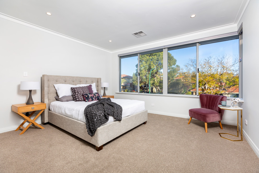 Contemporary master bedroom in Perth with carpet and beige floors.