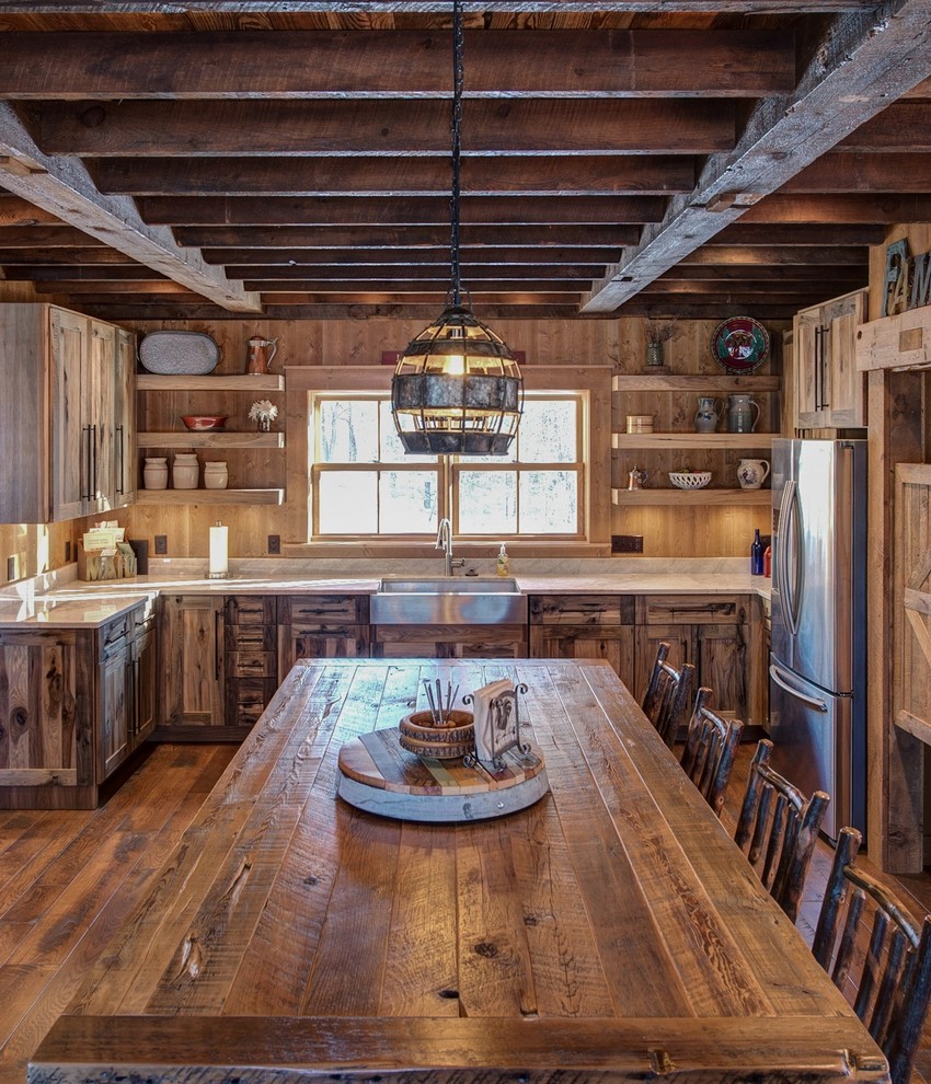 Design ideas for a country u-shaped eat-in kitchen in Minneapolis with a farmhouse sink, timber splashback, dark hardwood floors, flat-panel cabinets, distressed cabinets, quartzite benchtops and with island.