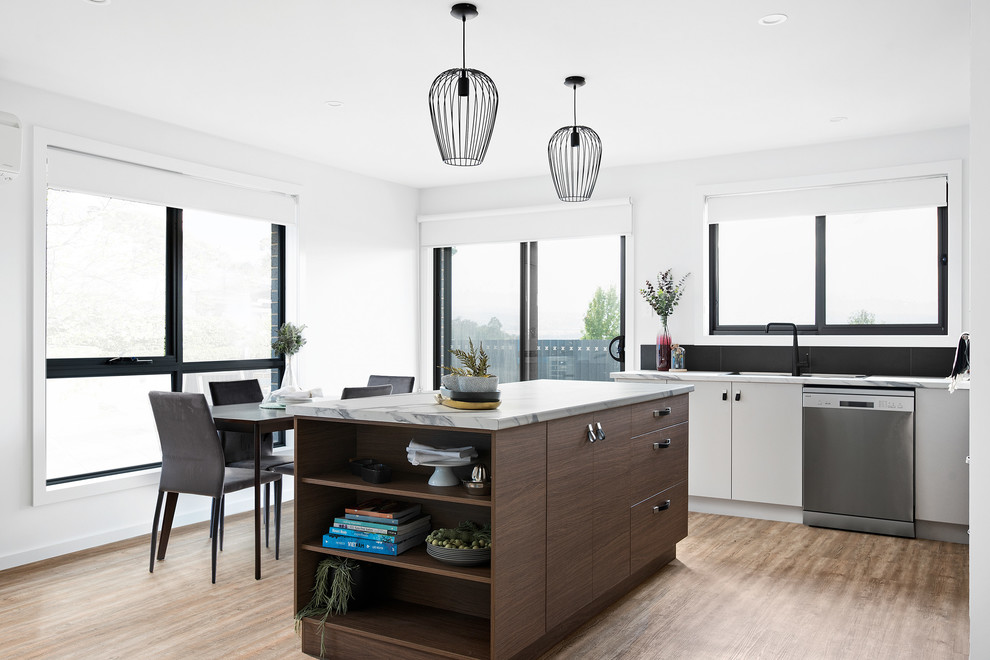 This is an example of a mid-sized contemporary galley open plan kitchen in Other with a single-bowl sink, recessed-panel cabinets, grey cabinets, laminate benchtops, black splashback, ceramic splashback, stainless steel appliances, vinyl floors, with island, brown floor and multi-coloured benchtop.