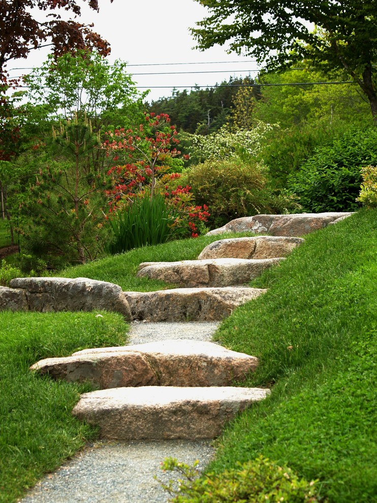 Inspiration for a mid-sized rustic partial sun backyard stone formal garden.