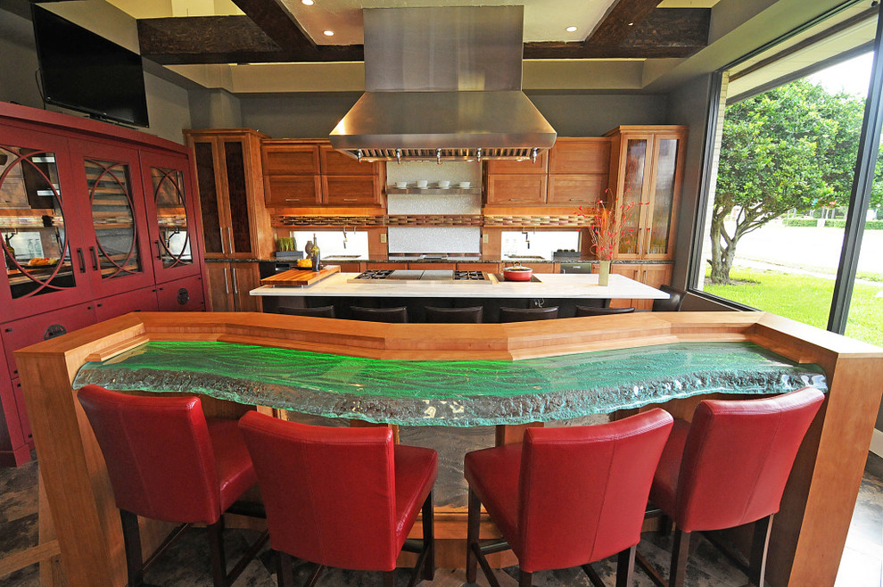This is an example of an asian kitchen in Orlando with glass benchtops and green benchtop.