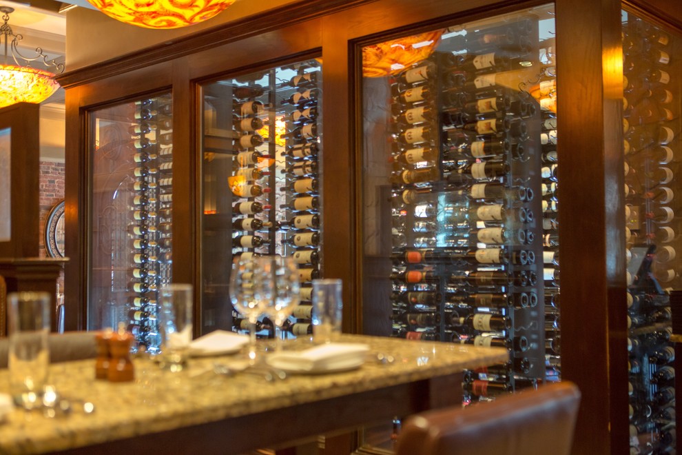 Design ideas for a contemporary wine cellar in Boston with brick floors and display racks.