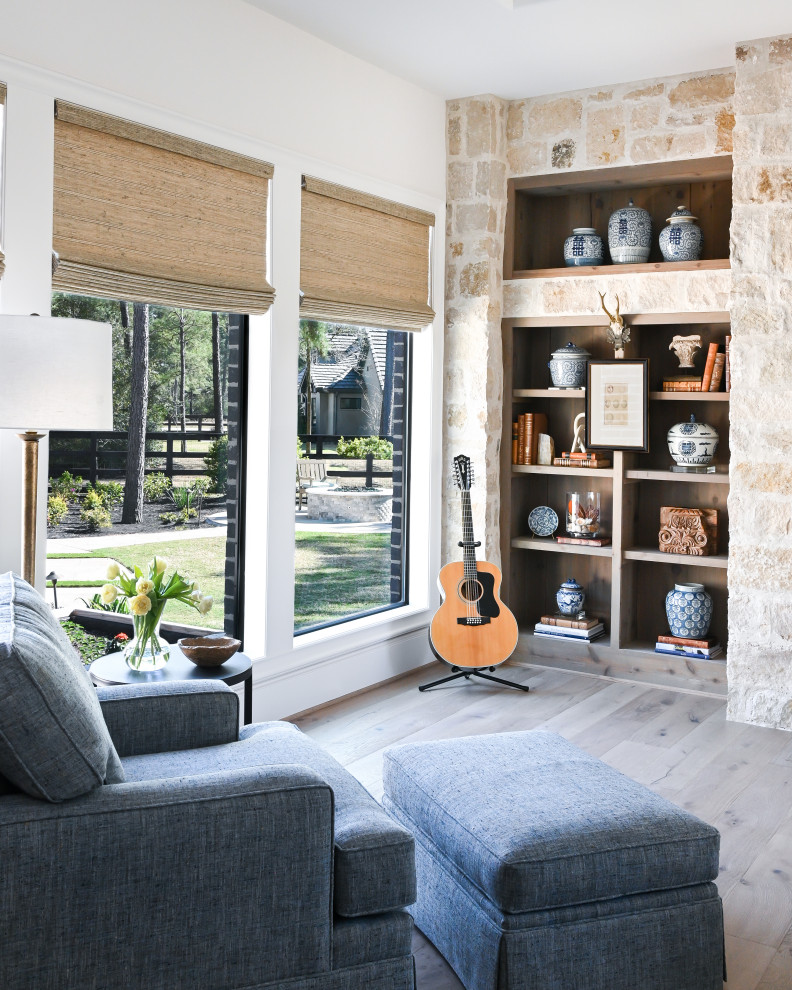 На фото: большая изолированная комната для игр с коричневыми стенами, паркетным полом среднего тона, стандартным камином, фасадом камина из камня и телевизором на стене