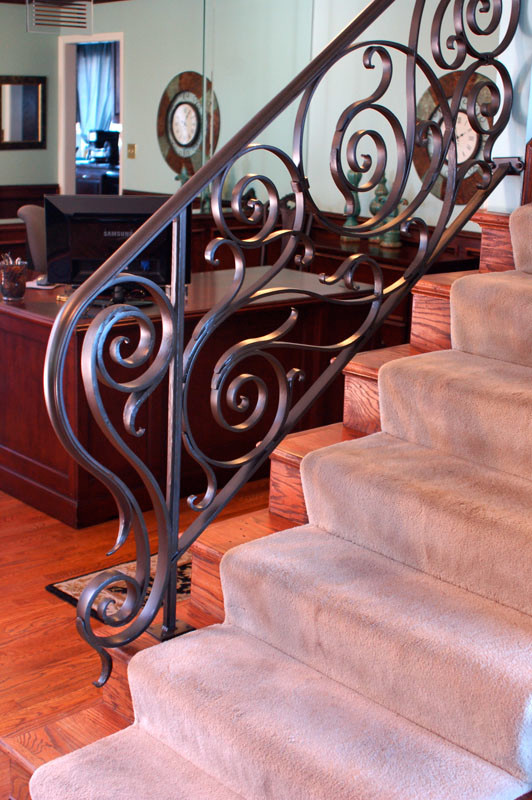 Inspiration for a mid-sized contemporary carpeted straight staircase in Kansas City with carpet risers and metal railing.