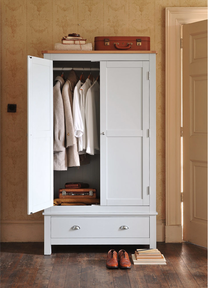 Design ideas for a mid-sized country storage and wardrobe in Other with brown floor.