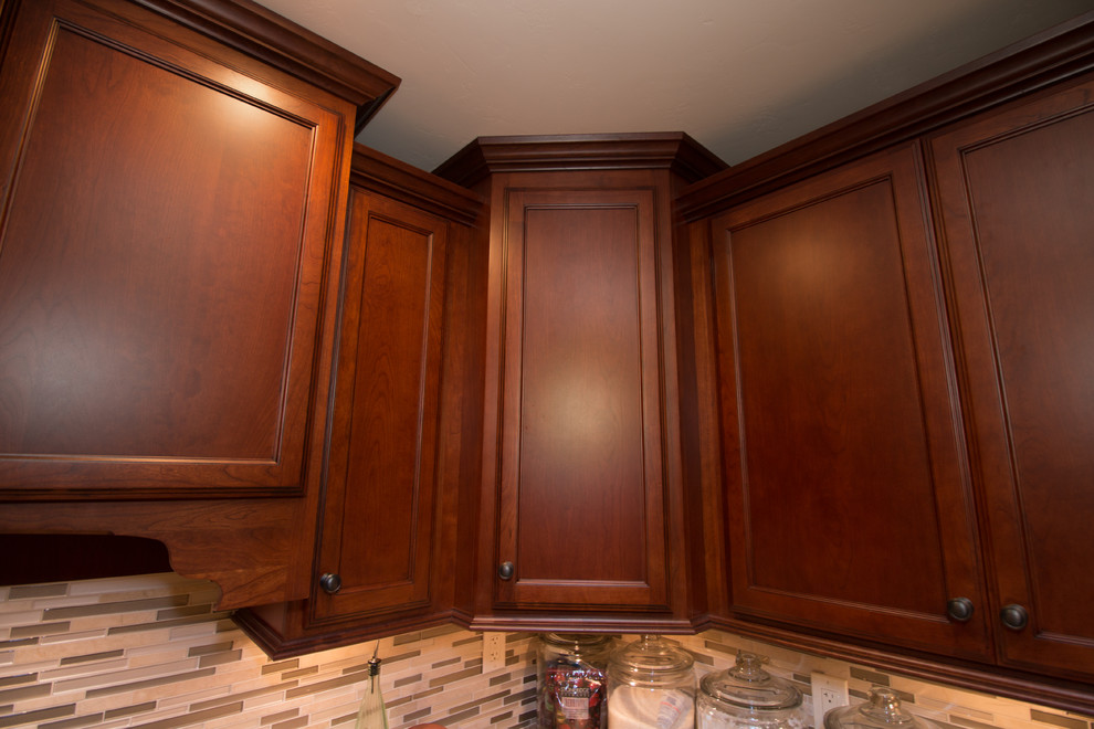 Kitchen - large transitional u-shaped porcelain tile kitchen idea with an undermount sink, flat-panel cabinets, medium tone wood cabinets, quartz countertops, beige backsplash, mosaic tile backsplash, stainless steel appliances and an island