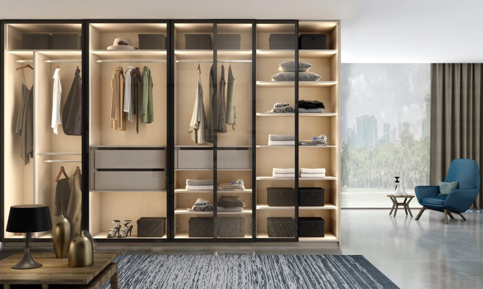 Mid-sized contemporary built-in wardrobe in London with glass-front cabinets.