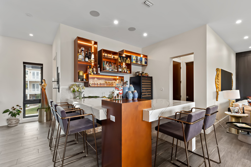 Small contemporary galley home bar in Tampa with an undermount sink, flat-panel cabinets, grey cabinets, marble benchtops, vinyl floors, grey floor and white benchtop.
