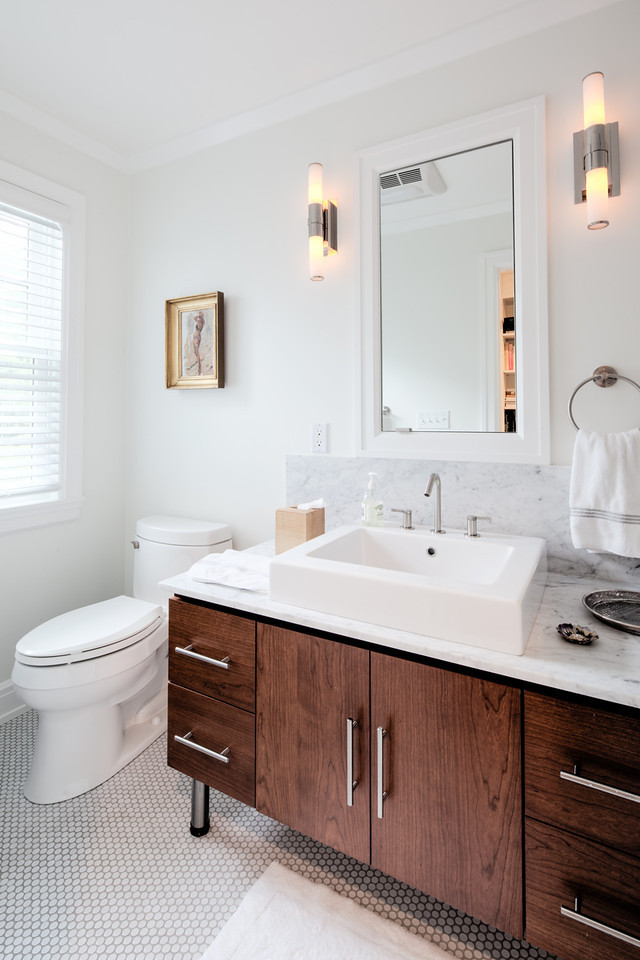Mid-sized traditional powder room in New York with flat-panel cabinets, dark wood cabinets, a one-piece toilet, grey walls, mosaic tile floors, a vessel sink and marble benchtops.