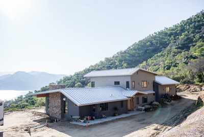 Mid-sized rustic gray two-story concrete fiberboard exterior home idea with a metal roof