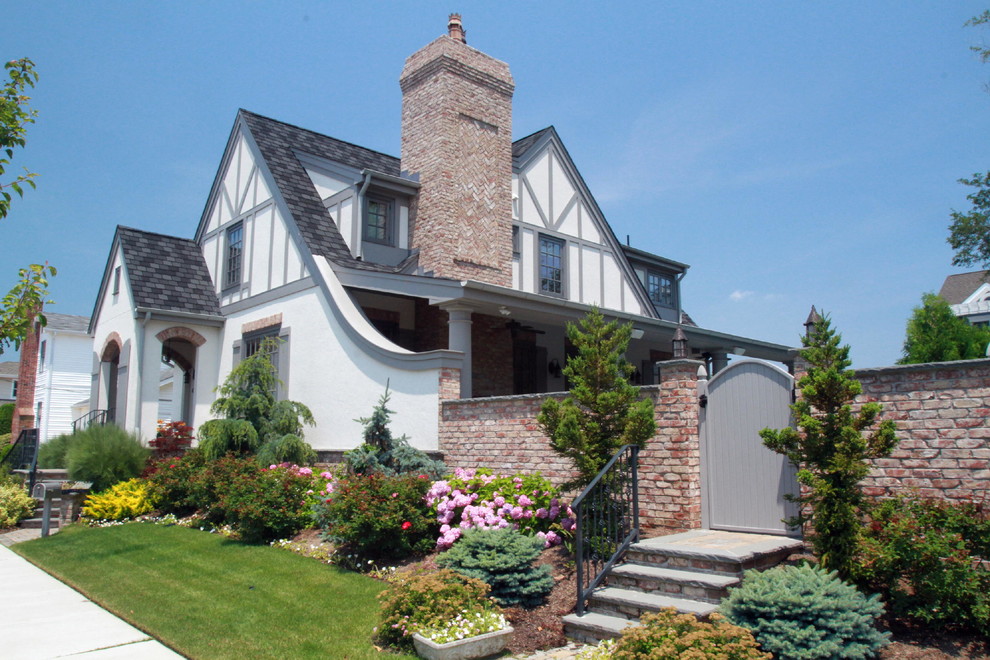 Large eclectic two-storey stucco white exterior in Philadelphia with a gable roof.