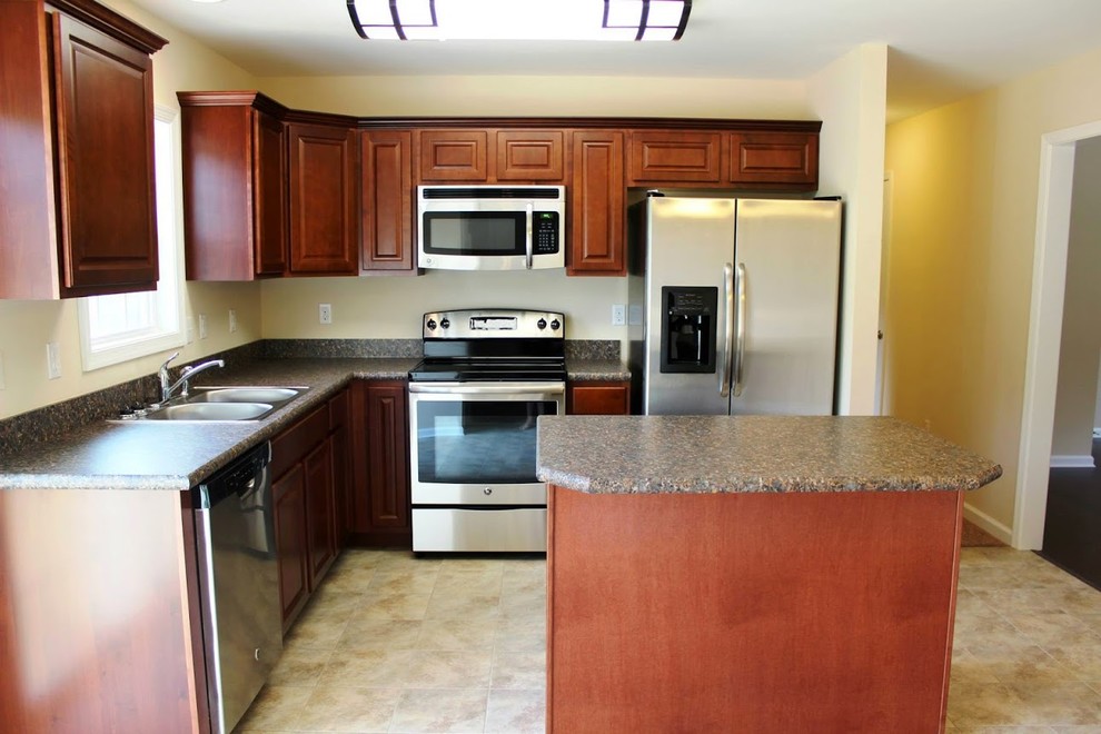 Inspiration for a transitional kitchen remodel in Baltimore with medium tone wood cabinets, stainless steel appliances and an island