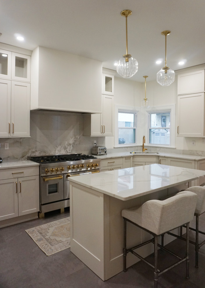 Inspiration for a transitional vinyl floor and gray floor kitchen remodel with an undermount sink, shaker cabinets, gray cabinets, quartzite countertops, stone slab backsplash, stainless steel appliances and an island