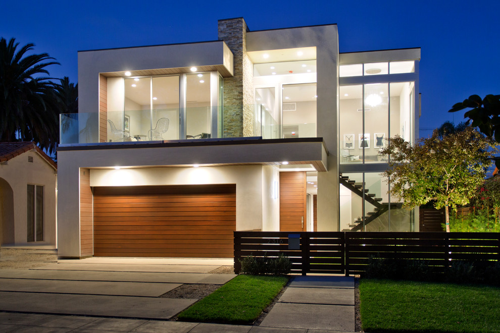 This is an example of a contemporary two-storey beige exterior in Los Angeles with a flat roof.
