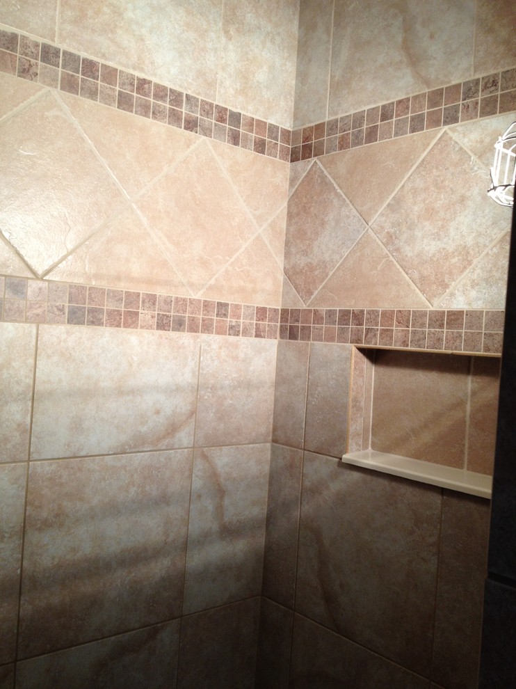 Example of a mid-sized beige tile and ceramic tile doorless shower design
