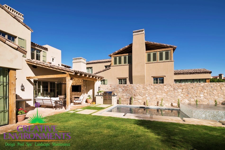 Example of a mid-sized mountain style backyard decomposed granite and rectangular pool fountain design in Phoenix
