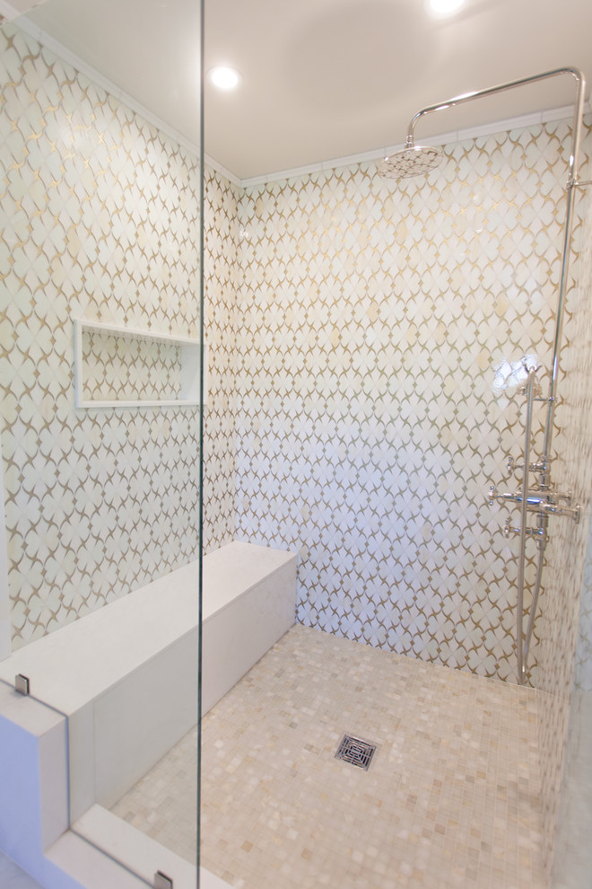 This is an example of a contemporary master bathroom in Los Angeles with furniture-like cabinets, marble benchtops, a claw-foot tub, an open shower, beige tile, glass tile, beige walls and mosaic tile floors.
