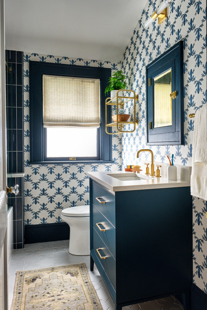 Alcove bathtub - transitional blue tile gray floor, single-sink, vaulted ceiling and wallpaper alcove bathtub idea in Charlotte with flat-panel cabinets, blue cabinets, blue walls, an undermount sink, beige countertops and a freestanding vanity