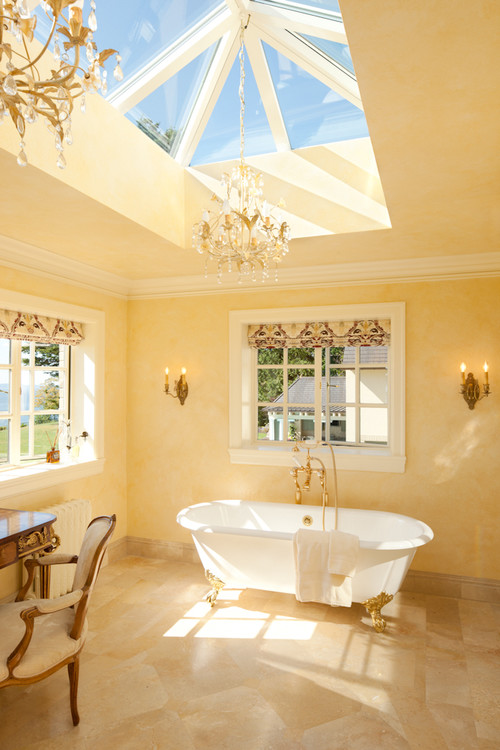 Natural light pours through large windows in this master bath.