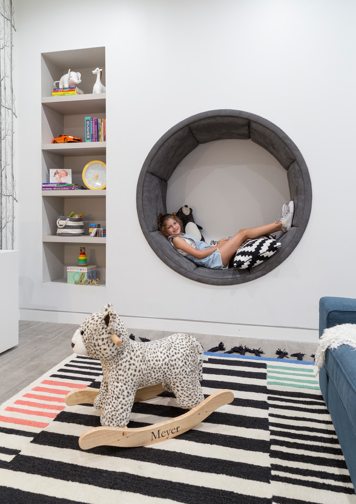 Design ideas for a large contemporary gender-neutral kids' playroom for kids 4-10 years old in Miami with white walls, porcelain floors and grey floor.