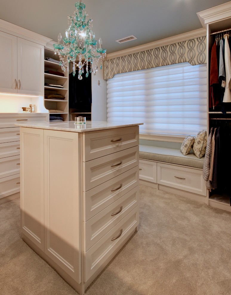 Inspiration for a large traditional gender-neutral walk-in wardrobe in Other with white cabinets, carpet, beige floor and recessed-panel cabinets.