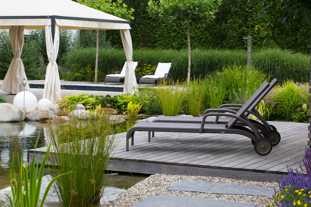 Design ideas for an expansive traditional backyard deck in Other with a water feature and no cover.